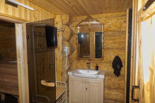 a bathroom with a sink and a mirror at Pirtis pas Astą 