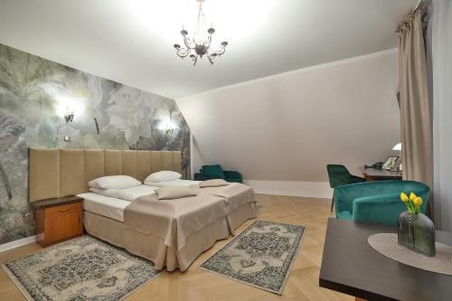 a bedroom with a bed and a chandelier at Hotel Wiosna in Rabka