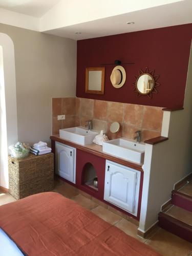 a bathroom with two sinks and two mirrors at Le Jas du Romarin in Callas