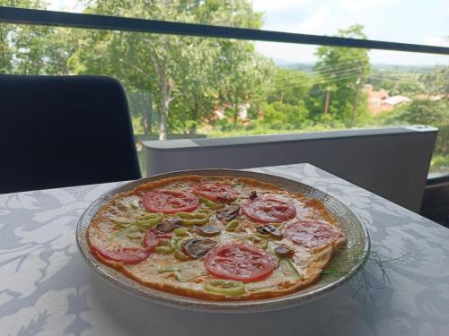 a pizza sitting on top of a table at Loven dom Berovo in Berovo