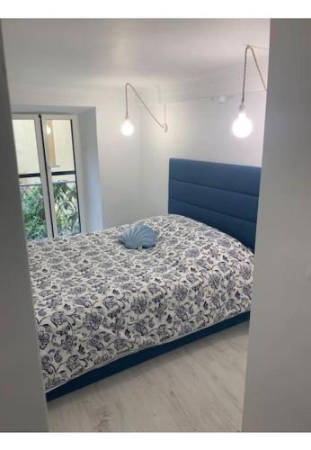 a bedroom with a bed with a blue head board at Nouveau - Nice Mamac - centre in Nice
