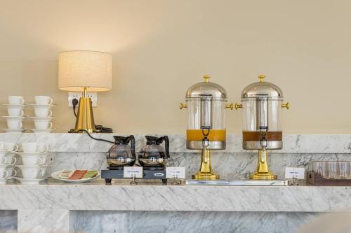 a counter with cups and coffee makers on it at Otres Beach Hotel in Sihanoukville