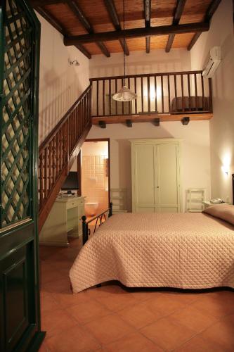 a bedroom with a bed and a staircase at Lumia in Riposto