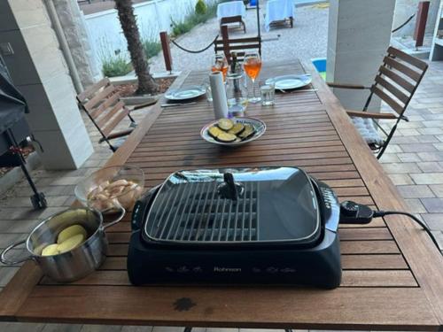 a toaster sitting on a wooden table on a patio at House between beaches in Vir