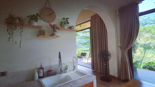 a bathroom with a sink and a large window at Dốc Chill - Villa gần Ba Vì, view núi, gần hồ, 40ph đi từ trung tâm Hà Nội in Hanoi