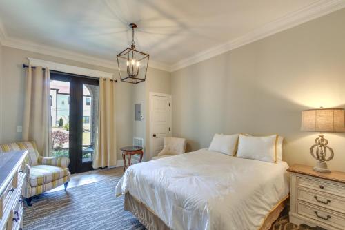 a bedroom with a white bed and a chair at Loretto Vacation Rental with Community Resort Perks in Loretto