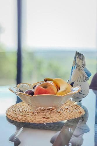 a bowl of fruit sitting on a table at Solana's View - Ferienhäuser in ruhiger Lage, mit einer einzigartigen Aussicht, Infinity Pool, Free Parking und Wlan in Ulcinj