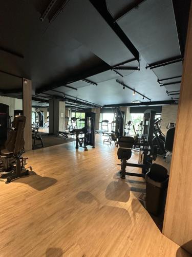 a gym with several treadmills and exercise equipment at Letnica41 by MYPART in your apartment in Gdańsk