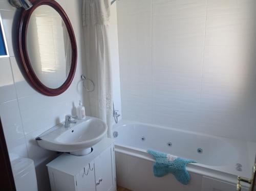 a bathroom with a sink and a mirror and a tub at La Via Verde in Miguel-Ibáñez