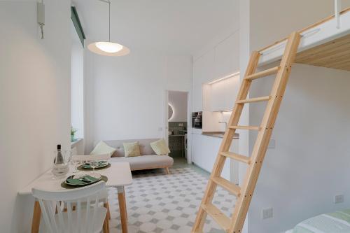 a living room with a ladder and a living room at Oliva Apartment in Imperia