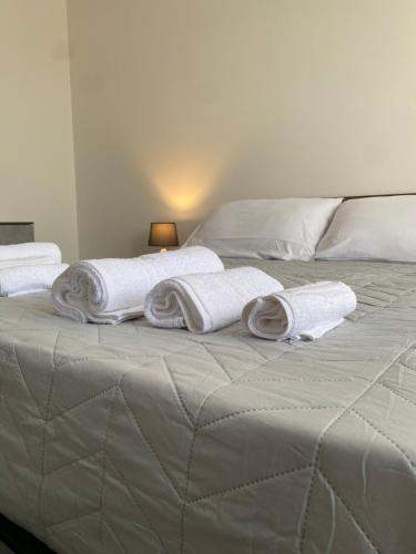 a bed with towels and pillows on top of it at [la terrazza del sole] in Menfi