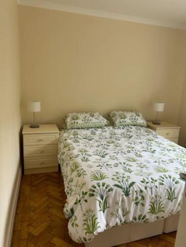 a bedroom with a bed and two night stands at Ranikhet in Risca