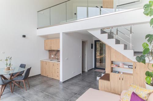 a kitchen and dining room with a staircase in a house at Solana's View - Ferienhäuser in ruhiger Lage, mit einer einzigartigen Aussicht, Infinity Pool, Free Parking und Wlan in Ulcinj