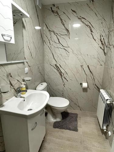 a bathroom with a white sink and a toilet at Katerina Apartments 9 in Velingrad