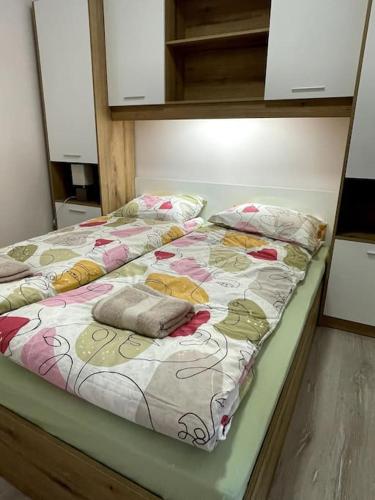 a bed with pillows on it in a room at Katerina Apartments 9 in Velingrad