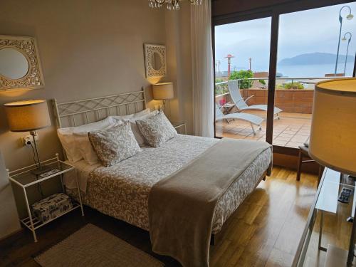 1 dormitorio con 1 cama y balcón en Vistas magnificas Islas Atlanticas, en Baiona