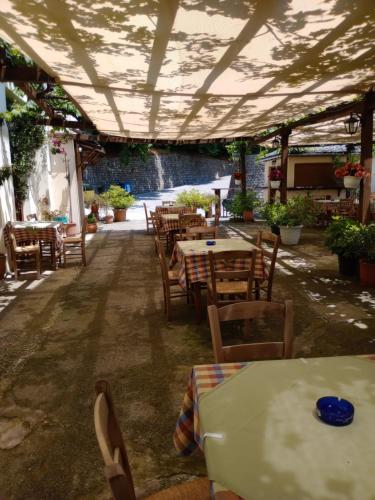 an outdoor patio with tables and chairs and a lot at Hotel Erotas in Agios Dimitrios