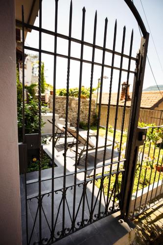 an iron gate with a view of a patio at Pietralago, Casa con vista sul Lago in Blevio