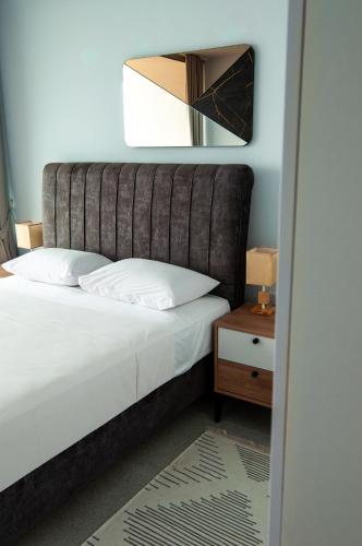 a bedroom with a bed and a mirror at Seaview apartments in Ayios Elias