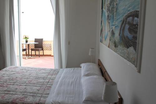 a bedroom with a bed and a large window at Hotel Esperia in Capri