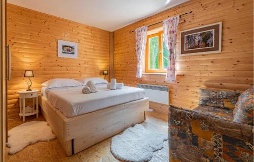 een slaapkamer met een bed in een blokhut bij Pet Friendly Home In Mazin With Sauna in Mazin