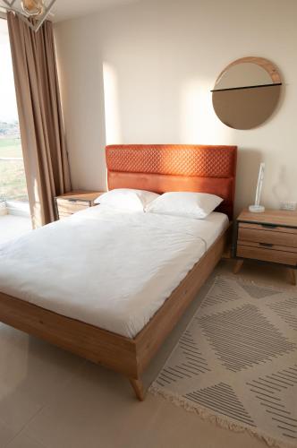 a bed with a wooden headboard in a bedroom at Seaview apartments in Ayios Elias