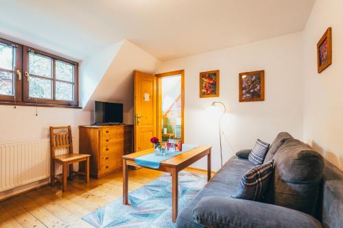 a living room with a couch and a table at Penzion Tilia in Český Krumlov