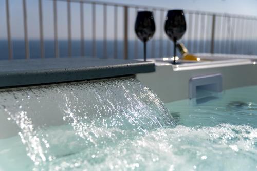 two glasses of wine in a pool of water at Villa Nina in Positano