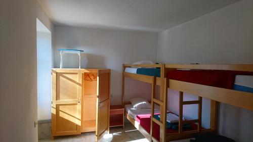 a room with two bunk beds and a cabinet at APF France handicap - Ferme Léonie in Saint-Laurent-en-Grandvaux