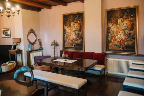 a waiting room with a table and a red couch at Pliades Traditional Guesthouse in Palaios Panteleimon