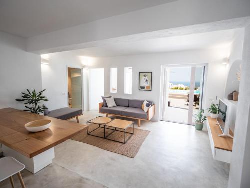 a living room with a couch and a table at Valery Suites in Fira