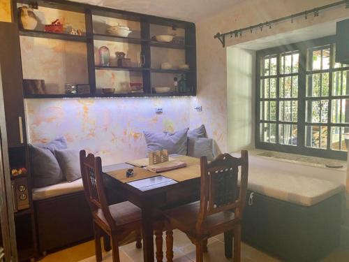 a dining room with a table and chairs and a couch at Seaside dream in Trstenik