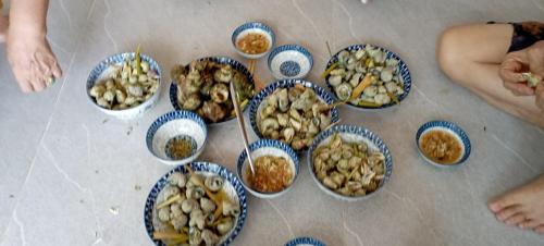 a group of bowls of food on the floor at Villa mặt biển - bờ kè Đông Hải in Ninh Hòa