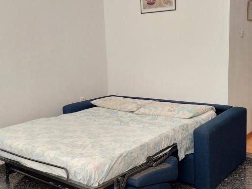a bed with a blue frame in a room at Apartment Riba in Ankaran