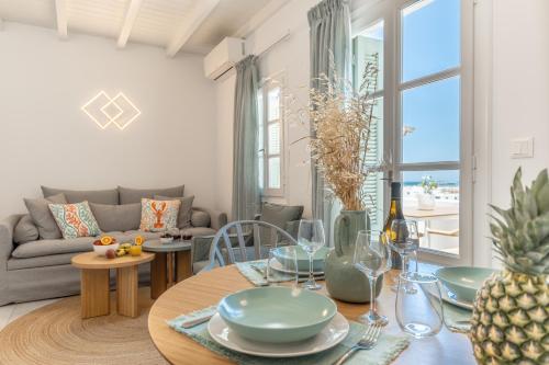 a living room with a table and a couch at Caruana Inland Naxos in Agia Anna Naxos