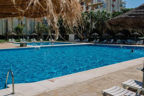 ベナルマデナにあるAmanecer en el marのホテル内の青い水のスイミングプール