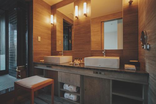 a bathroom with two sinks and two mirrors at KANAYA RESORT HAKONE in Hakone