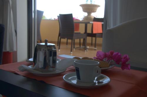 a table with a tea kettle and a cup of coffee at Hotel Esperia in Capri