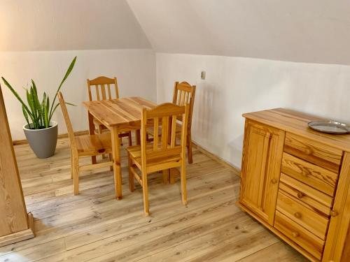 a dining room with a wooden table and chairs at Gościniec Rzemyk in Wdzydze Kiszewskie