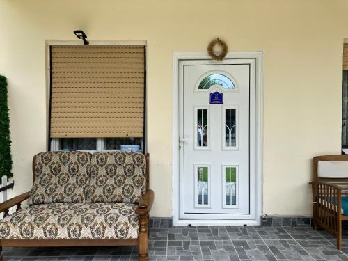 a couch sitting in front of a door at Apartamani Evelin in Veliko Gradište