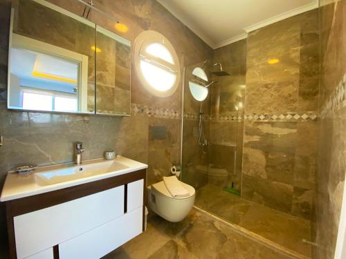 a bathroom with a sink and a toilet and a shower at Paris A Villa, Özel Havuzlu, Fethiye in Fethiye