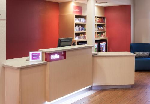 a waiting area at a drugstore with a reception counter at TownePlace Suites Dallas Arlington North in Arlington