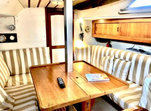 a coffee table with a remote control on a table at Casa Veleiro SHALOM in Ponta Delgada