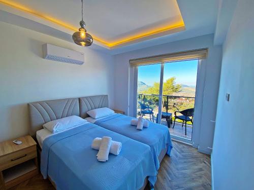 a bedroom with two beds with towels on them at Paris A Villa, Özel Havuzlu, Fethiye in Fethiye