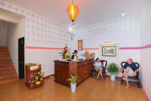 a group of people sitting at a counter in a room at Cua Dai Beach Homestay in Hoi An