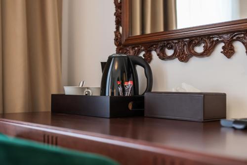 a tea kettle sitting on a table in front of a mirror at Villa 1927 in Belgrade