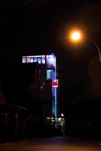 a lit up building at night with a street light at Huong Mai Hotel in Da Lat