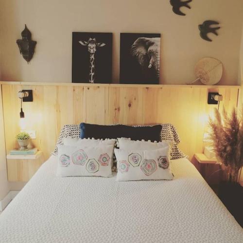 a bedroom with a white bed with four pillows at Rías Baixas. Acogedor piso en la Ría de Arousa in Ribeira