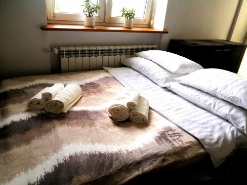 a bedroom with a bed with towels on it at Studio Syreny in Warsaw