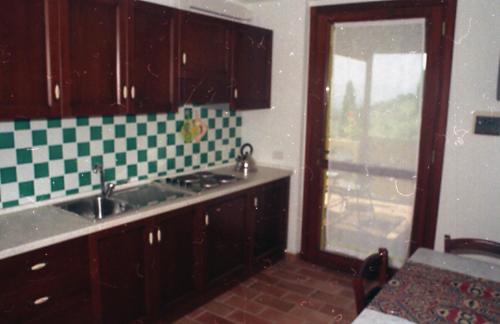 a kitchen with a sink and a window in it at Country House Il Sambro in Bettona